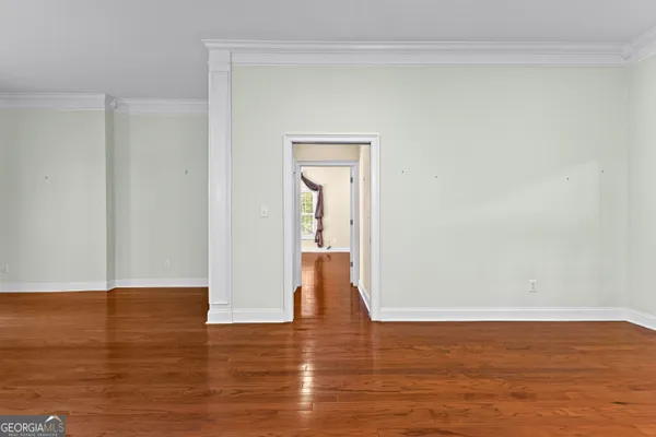 a view of an empty room with wooden floor