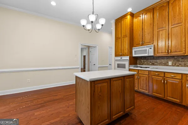 a view of empty room with wooden floor and floor to ceiling window