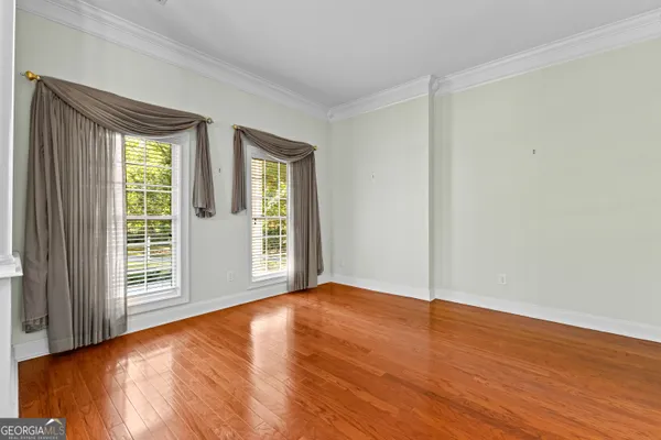 a view of a room with wooden floor a fireplace and window
