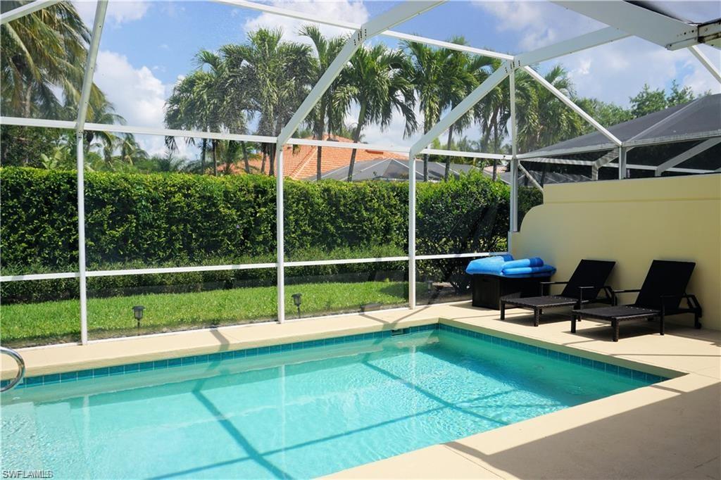4194 St George Lane Naples, FL 34119 - Photo 15 of 29 a view of a chair and tables in the backyard