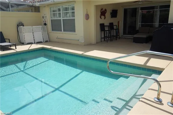 a backyard of a house with table and chairs