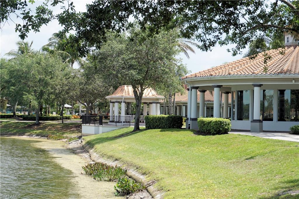 4194 St George Lane Naples, FL 34119 - Photo 18 of 29 a front view of a house with a yard