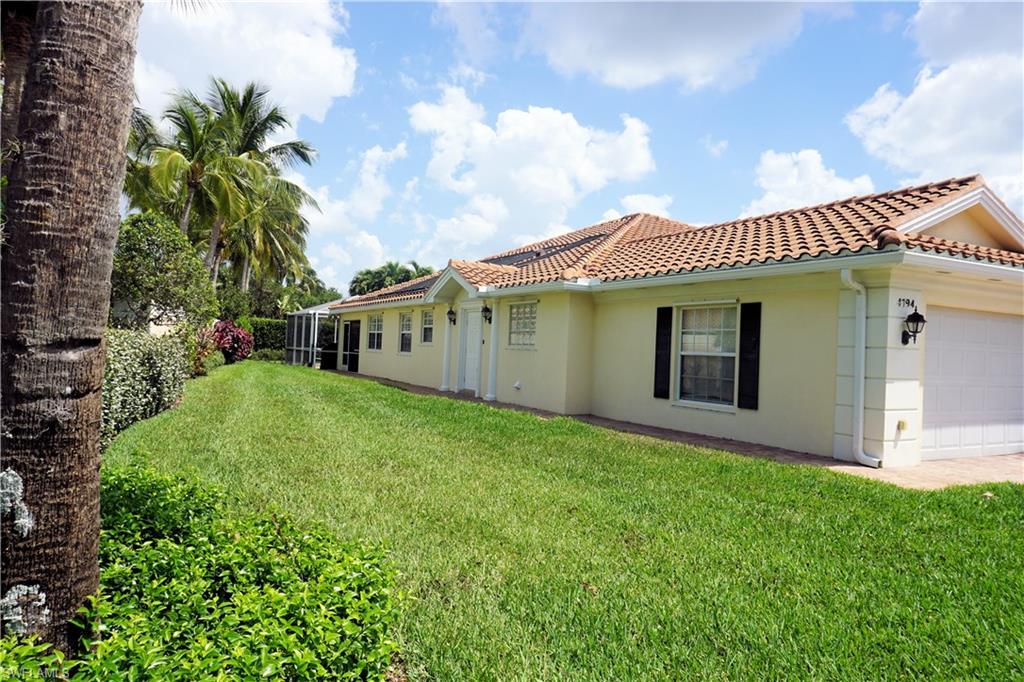 4194 St George Lane Naples, FL 34119 - Photo 4 of 29 a view of a house with a garden