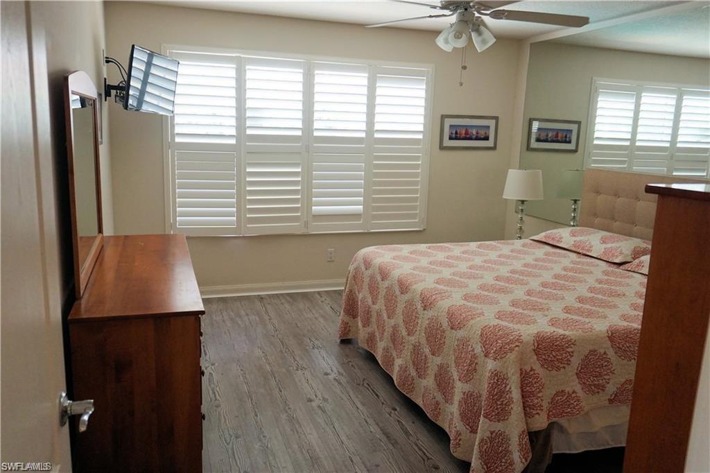 4194 St George Lane Naples, FL 34119 - Photo 10 of 29 a bedroom with a bed and a window