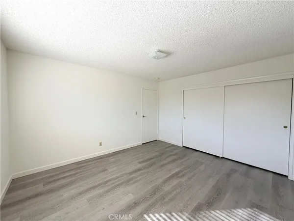 an empty room with wooden floor