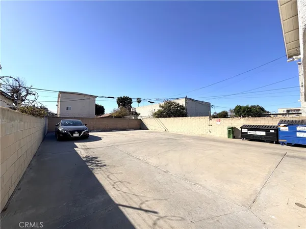 a view of a street with cars parked