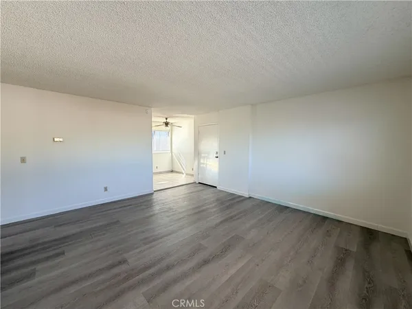 a view of an empty room and wooden floor