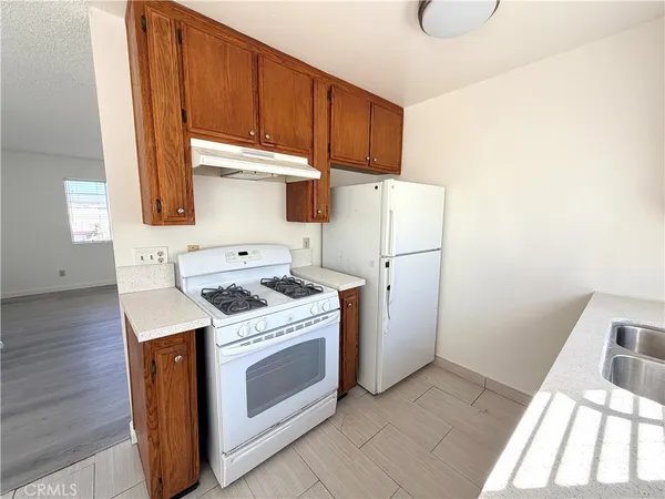 a kitchen with a stove top oven sink and a refrigerator