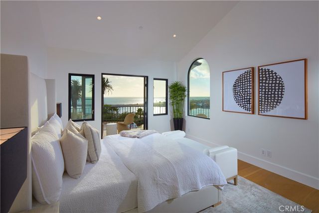 a large bedroom with a bed and large window