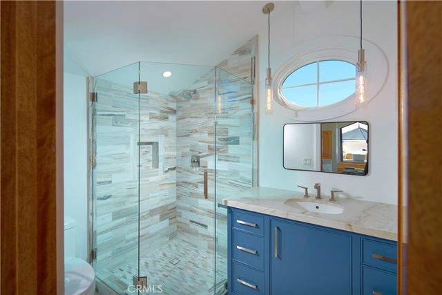 a bedroom with a large bed and large windows