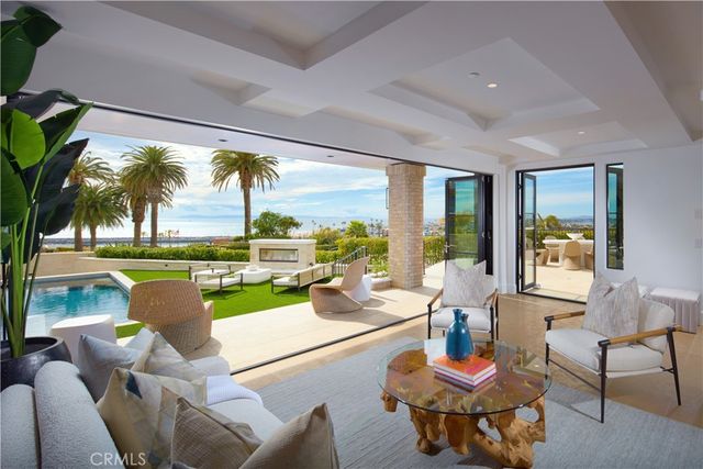 a living room with patio furniture and a floor to ceiling window