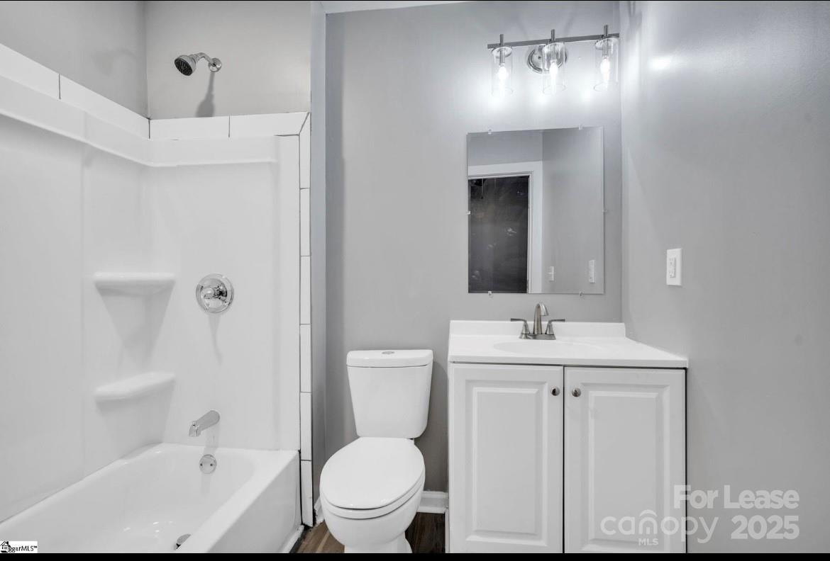 426 Arch Street Spartanburg, SC 29301 - Photo 11 of 13 a bathroom with a toilet a sink and mirror