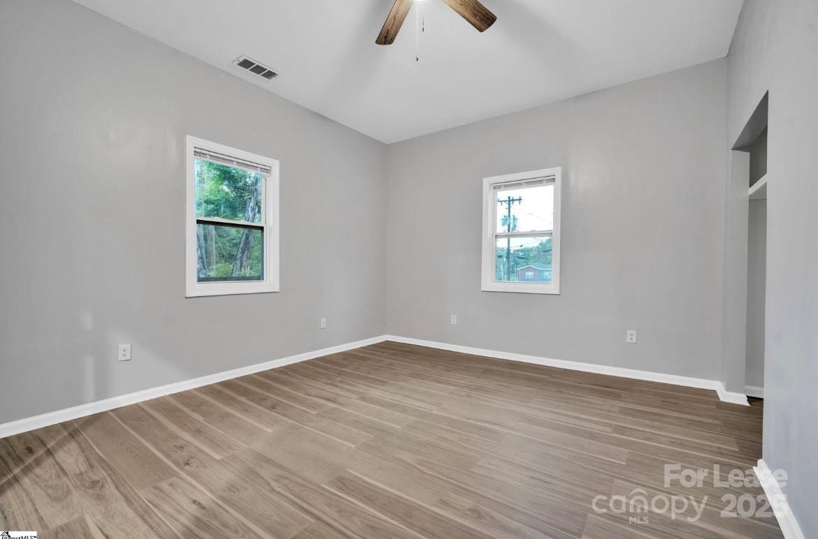 426 Arch Street Spartanburg, SC 29301 - Photo 13 of 13 wooden floor in an empty room with a window
