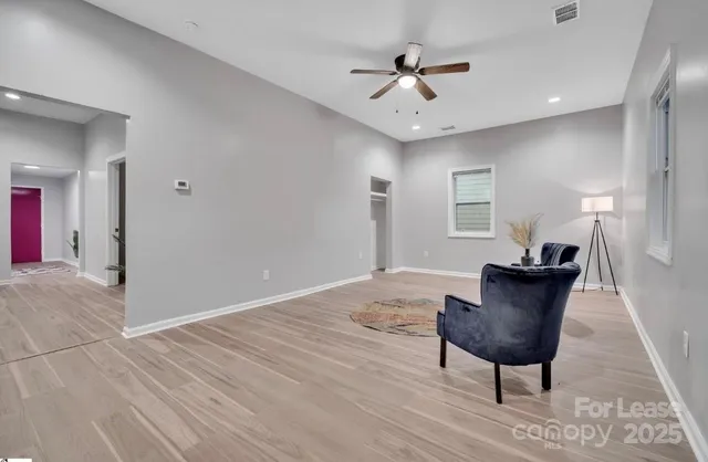 a view of a livingroom with furniture and wooden floor