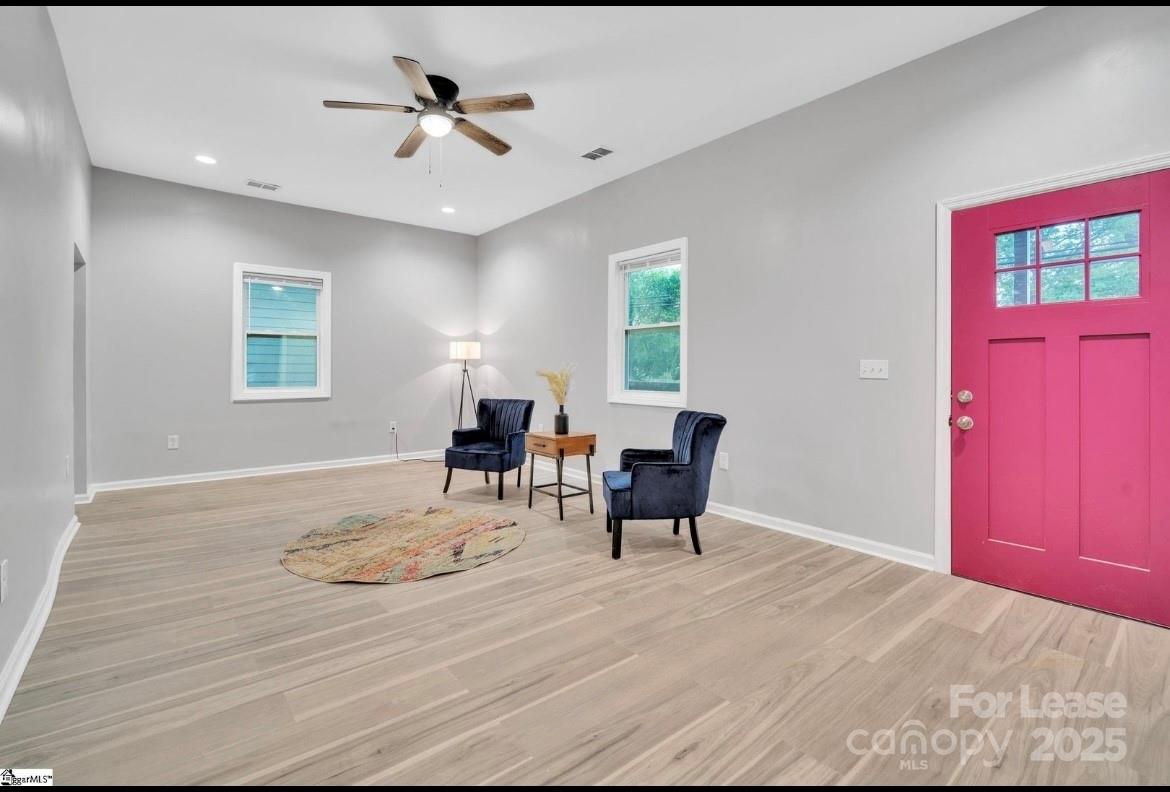 426 Arch Street Spartanburg, SC 29301 - Photo 3 of 13 a workspace with furniture a chandelier and wooden floor