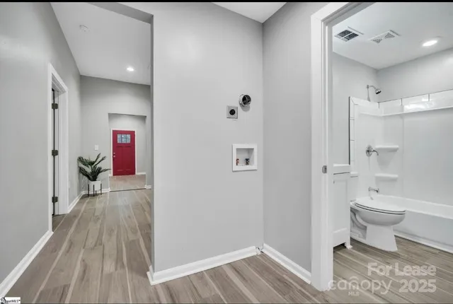 a bathroom with a toilet and a shower