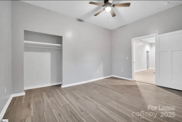 a view of an empty room with wooden floor