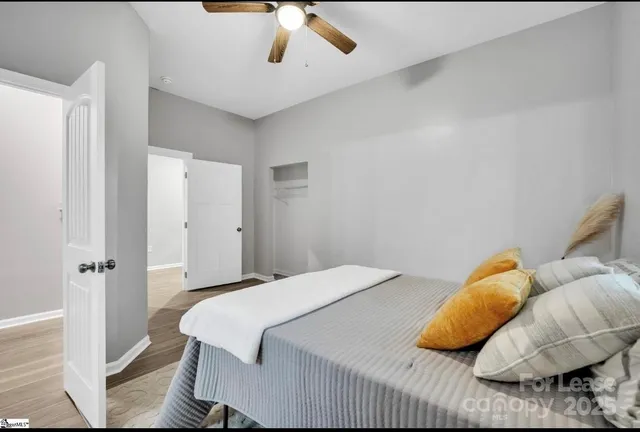 a bedroom with a bed and a ceiling fan