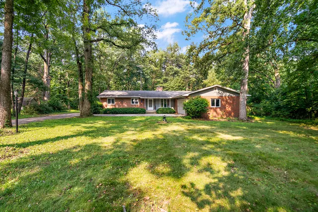 a front view of house with yard and green space