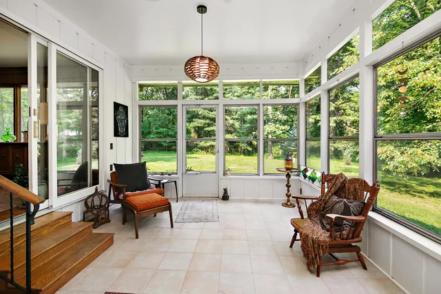 a living room with furniture and floor to ceiling windows