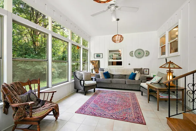 a living room with furniture windows and wooden floor