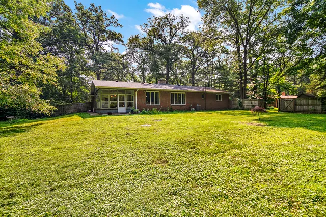 a view of a swimming pool and trees in the background
