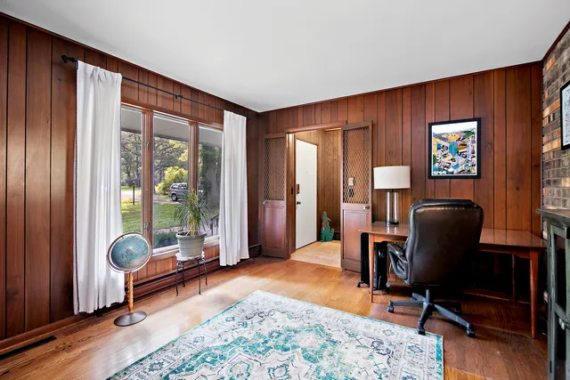a view of a livingroom with workspace and a window