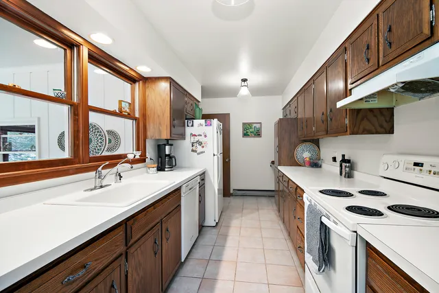 a kitchen with a sink stove and cabinets