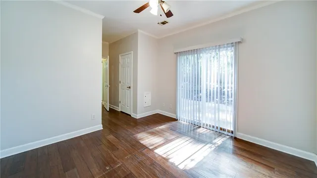 wooden floor in an empty room with a window