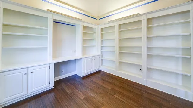 a view of walk in closet with empty racks