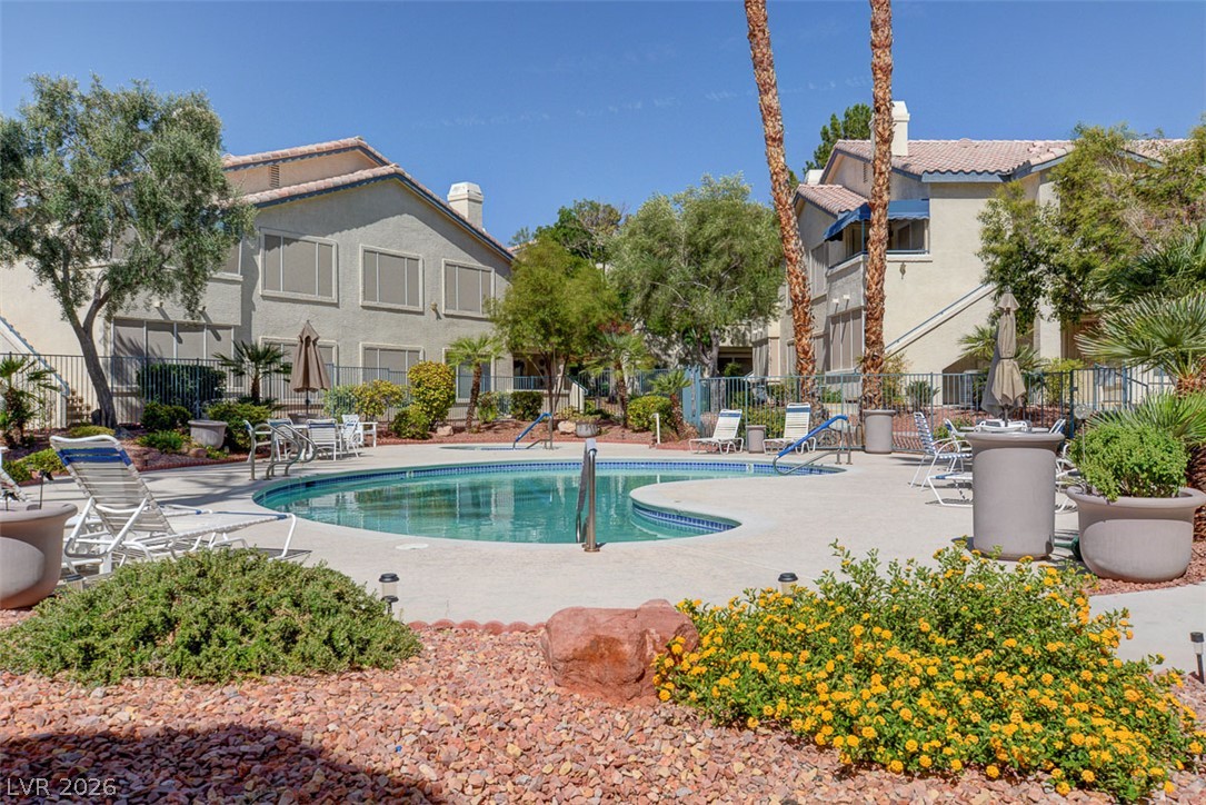 3425 East Russell Road, Unit 223 Las Vegas, NV 89120 - Photo 43 of 47 An inviting pool beckons relaxation amidst lush landscaping and residential charm.