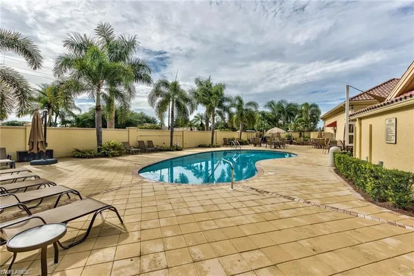 a view of a swimming pool with a lounge chair