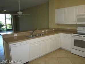 a kitchen with granite countertop a sink and a stove