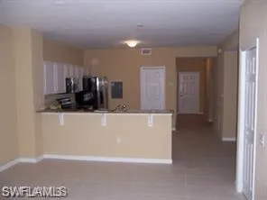 a view of kitchen with stainless steel appliances a refrigerator