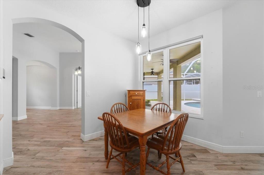 2214 Longmore Circle Valrico, FL 33596 - Photo 11 of 61 a view of a dining room with furniture window and wooden floor