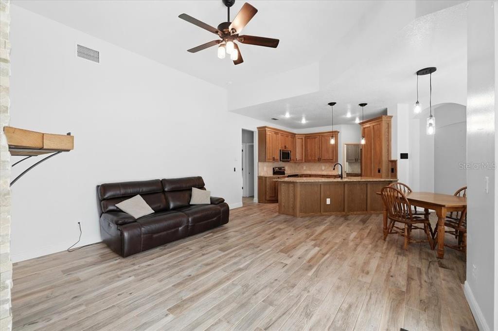 2214 Longmore Circle Valrico, FL 33596 - Photo 16 of 61 a living room with furniture and kitchen view