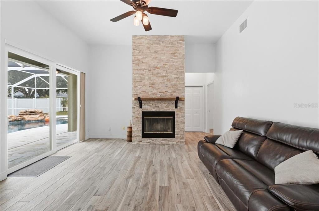 2214 Longmore Circle Valrico, FL 33596 - Photo 17 of 61 a living room with furniture and a fireplace