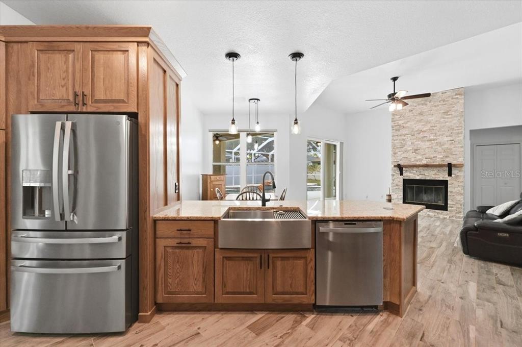 2214 Longmore Circle Valrico, FL 33596 - Photo 21 of 61 a kitchen with kitchen island a sink stove and refrigerator