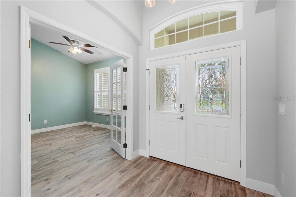 2214 Longmore Circle Valrico, FL 33596 - Photo 6 of 61 an empty room with wooden floor and windows