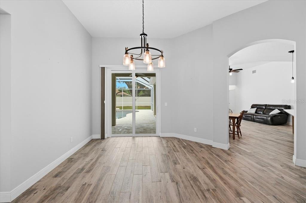 2214 Longmore Circle Valrico, FL 33596 - Photo 8 of 61 a living room with wooden floor and furniture
