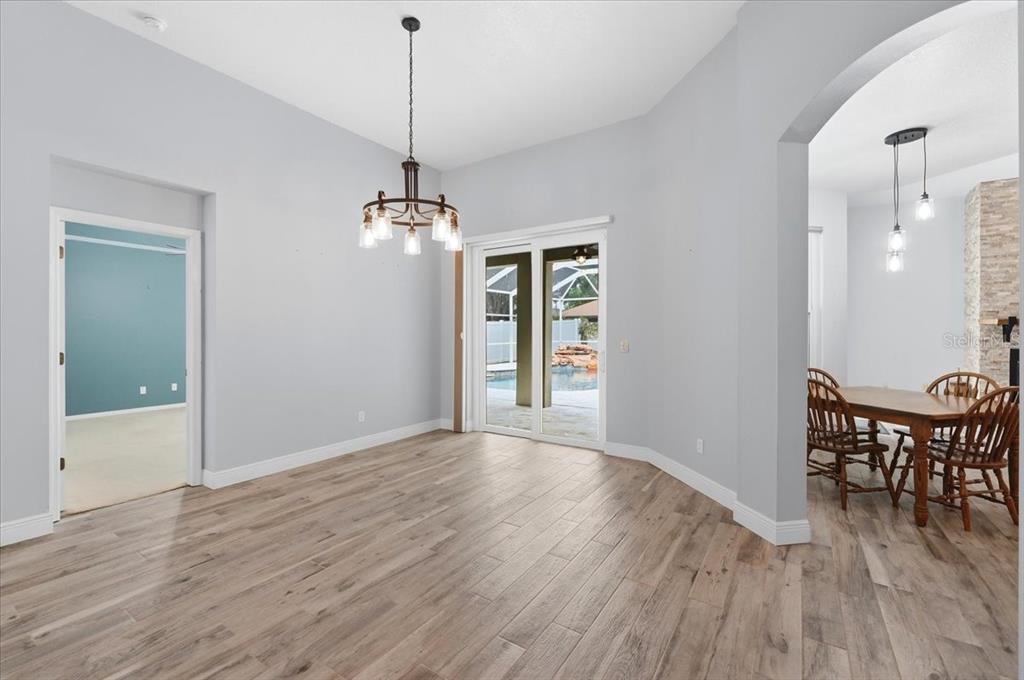2214 Longmore Circle Valrico, FL 33596 - Photo 10 of 61 a view of a room with wooden floor a ceiling fan and windows