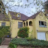a front view of a house with a garden