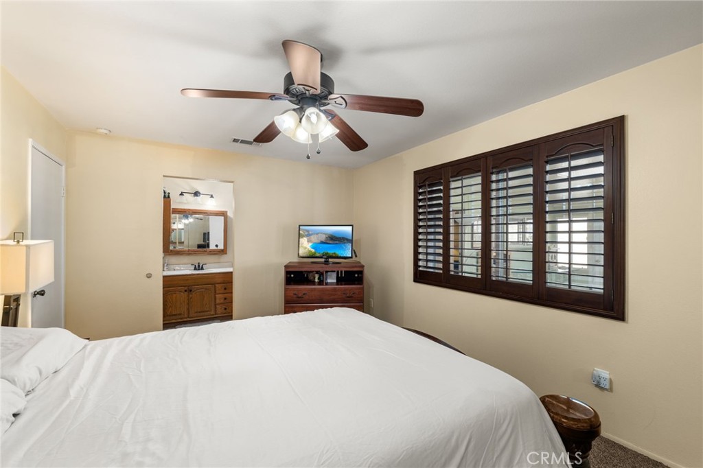 7221 Ramona Avenue Rancho Cucamonga, CA 91701 - Photo 14 of 30 a bedroom with a bed dresser and a large window