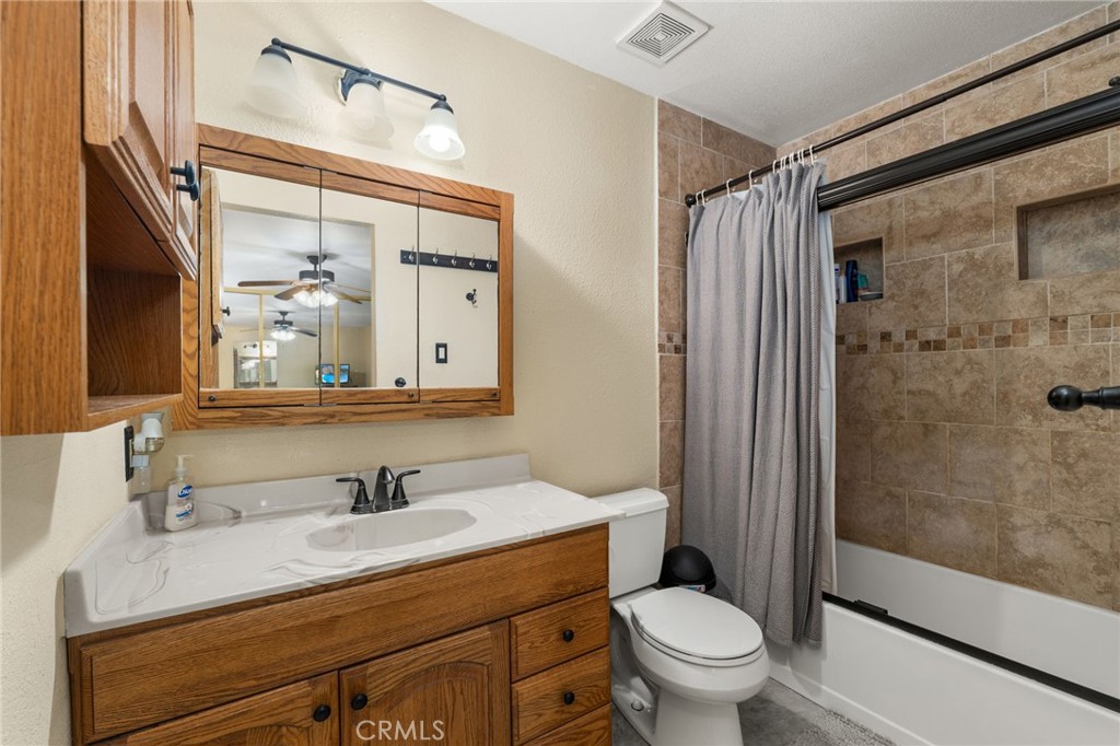 7221 Ramona Avenue Rancho Cucamonga, CA 91701 - Photo 15 of 30 a bathroom with a granite countertop sink toilet and shower