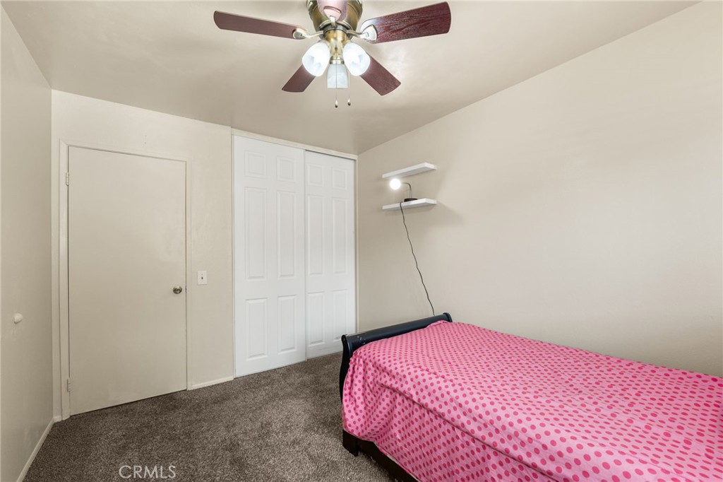 7221 Ramona Avenue Rancho Cucamonga, CA 91701 - Photo 20 of 30 a bedroom with a bed and a chandelier fan