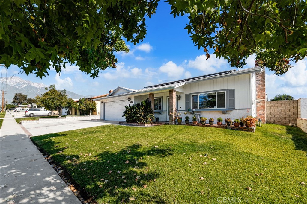 7221 Ramona Avenue Rancho Cucamonga, CA 91701 - Photo 3 of 30 a view of a house with a yard