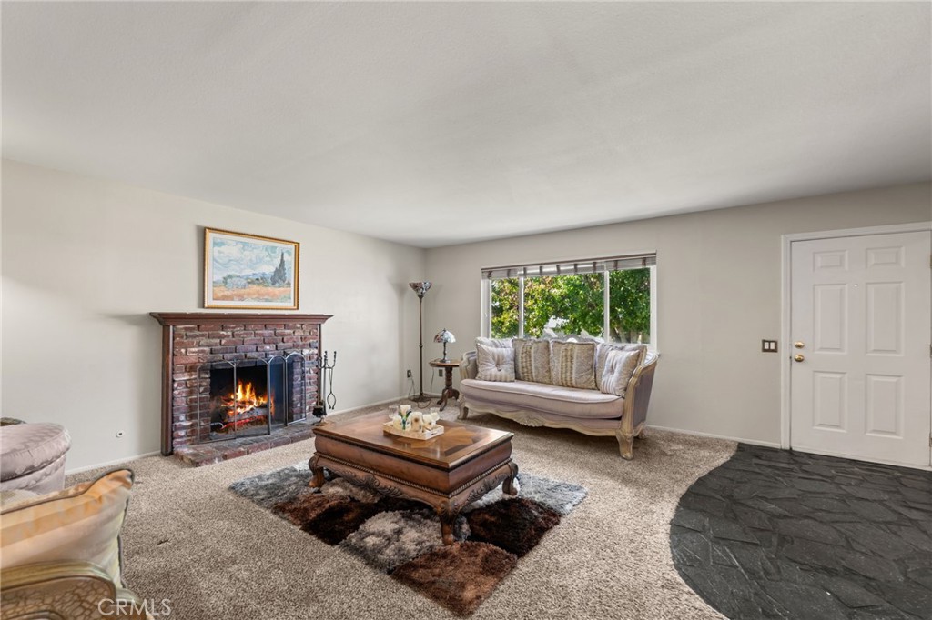 7221 Ramona Avenue Rancho Cucamonga, CA 91701 - Photo 4 of 30 a living room with furniture and a fireplace