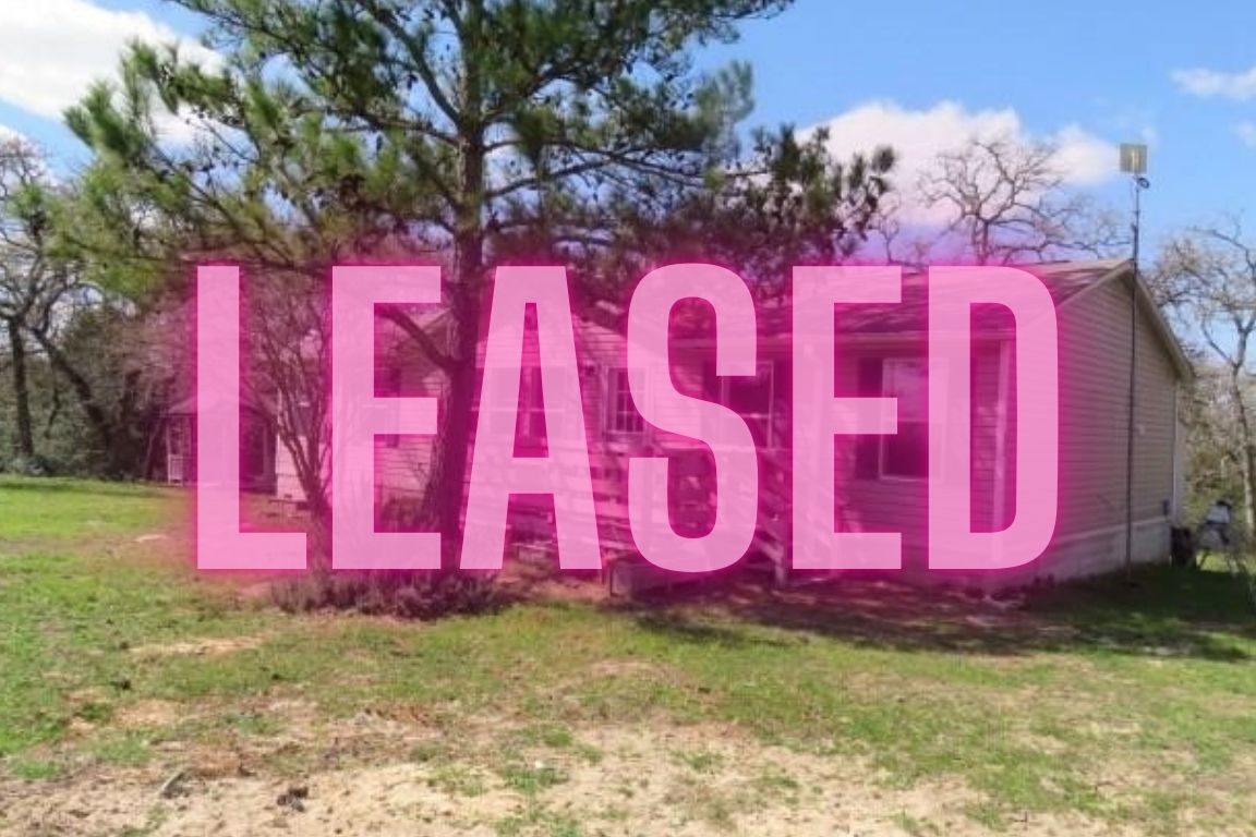 296 Country Lane McDade, TX 78650 - Photo 1 of 1 a sign board with a yard