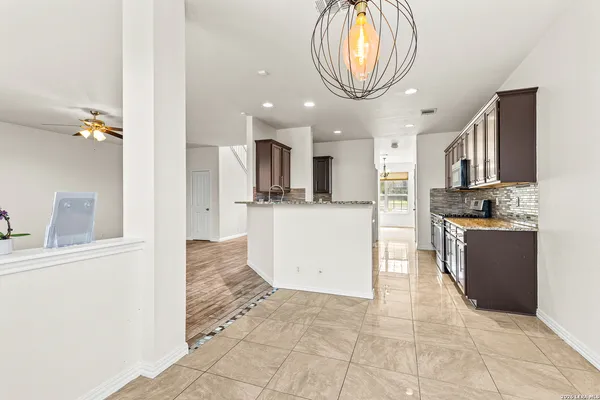 a kitchen with stainless steel appliances granite countertop a refrigerator and a stove top oven