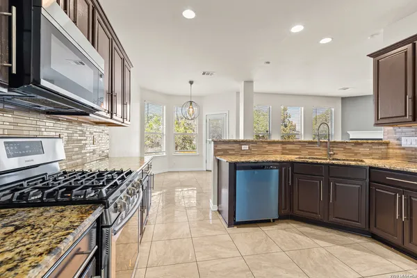 a kitchen with a sink stove and cabinets